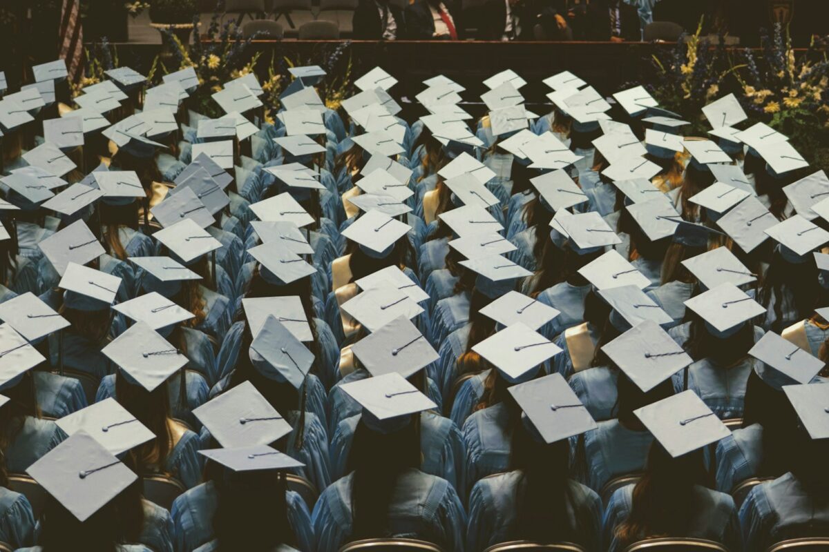 UK Graduate Visa vs PGWP graduates throwing caps at ceremony