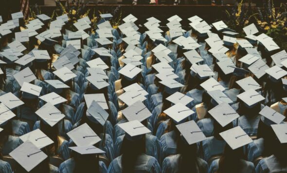 UK Graduate Visa vs PGWP graduates throwing caps at ceremony