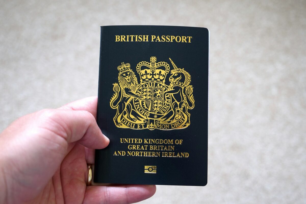 UK Skilled Worker Visa 2026 passport and pen on application form