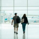 UK Spouse Visa 2026 couple walking through airport with luggage