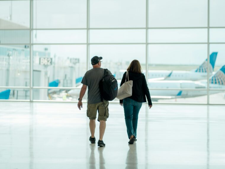 UK Spouse Visa 2026 couple walking through airport with luggage