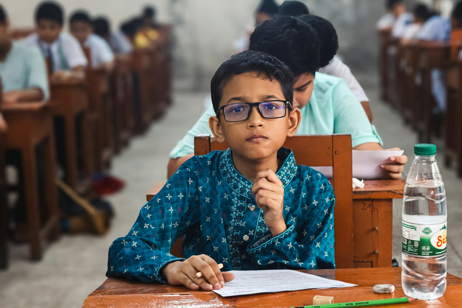 Student at a desk weighing the IELTS vs PTE English test choice
